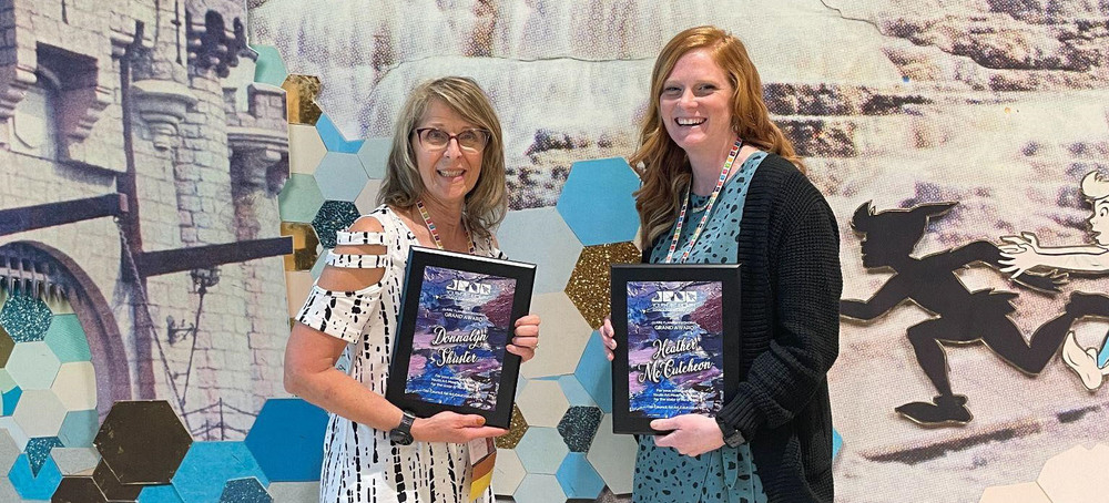 Heather McCutcheon and another art teacher with awards at national conference in Texas