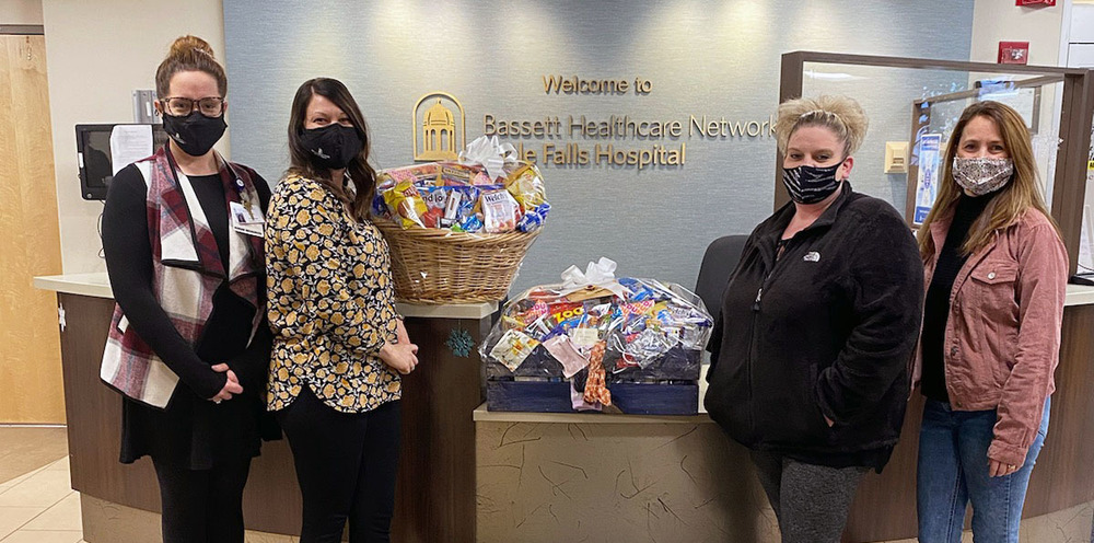 Little Falls Hospital staff and Pathways Academy Student Council advisors pose with goodie baskets delivered to Little Falls Hospital