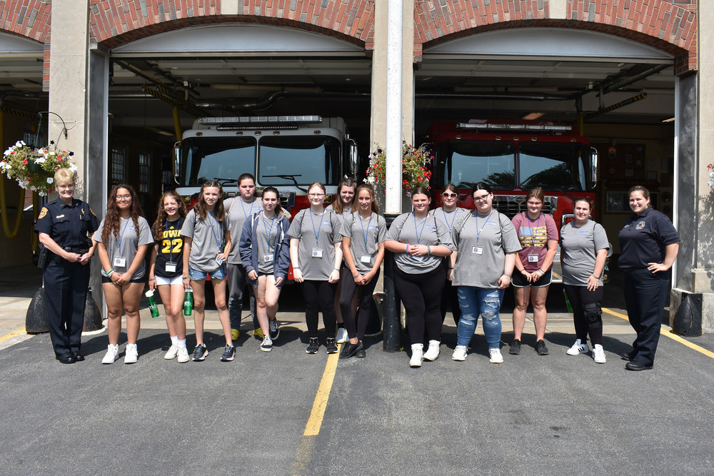 Rescue Heroes participants pose in front of the Ilion firehouse with police chief and firefighter