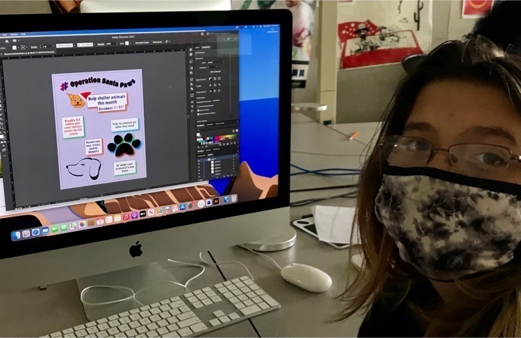 Student looks at camera with design in background on computer