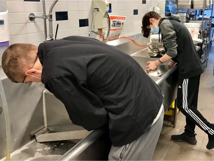 Two Culinary students cleaning