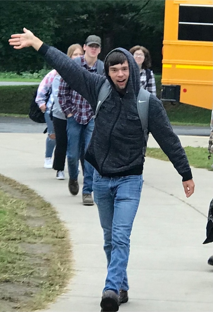 students waving