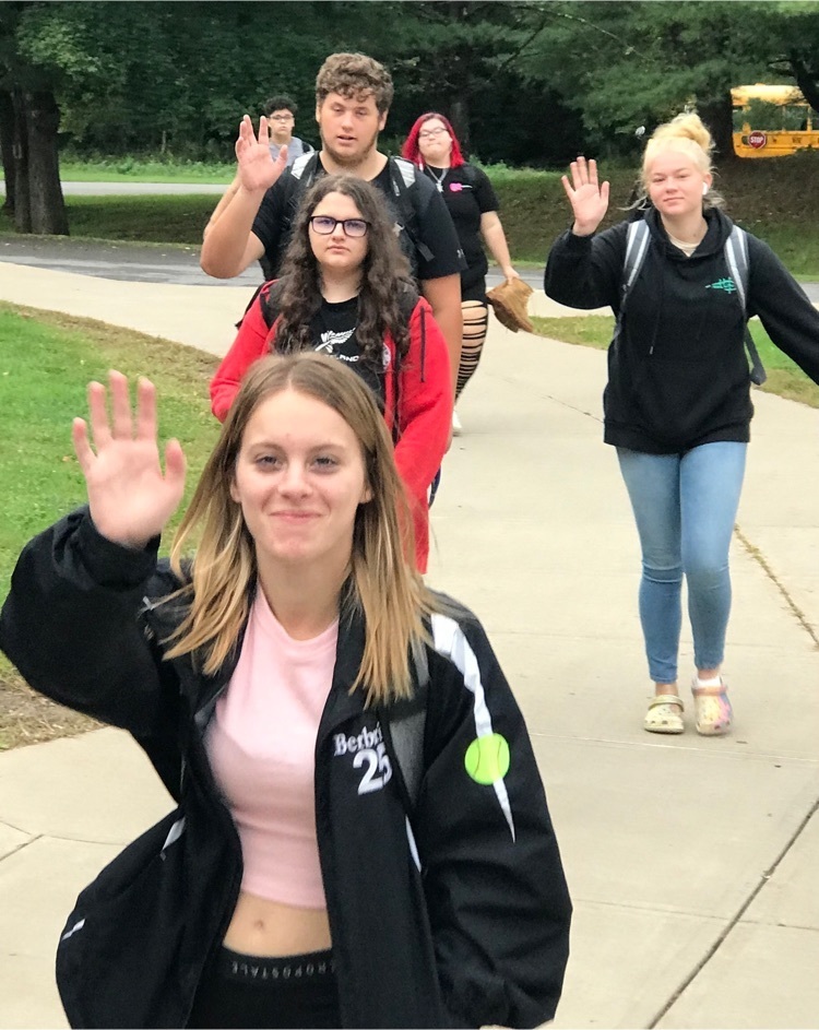 students waving 