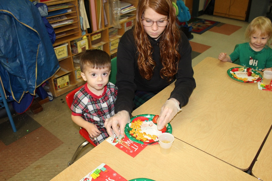 Child and Family Services student sitting with a Toddler Play Group child