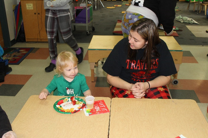 Child and Family Services student sitting with a Toddler Play Group child