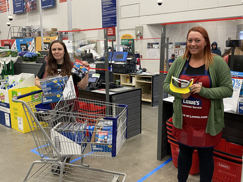 Lowe's workers holding donations for mask creation