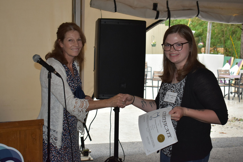 Scholarship Foundation President Sharon Baisley (left) presents a certificate to Chelsealynne Anna