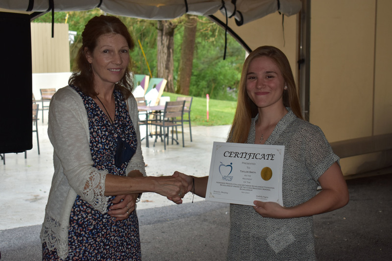 Scholarship Foundation President Sharon Baisley (left) presents a certificate to Taylor Smith,