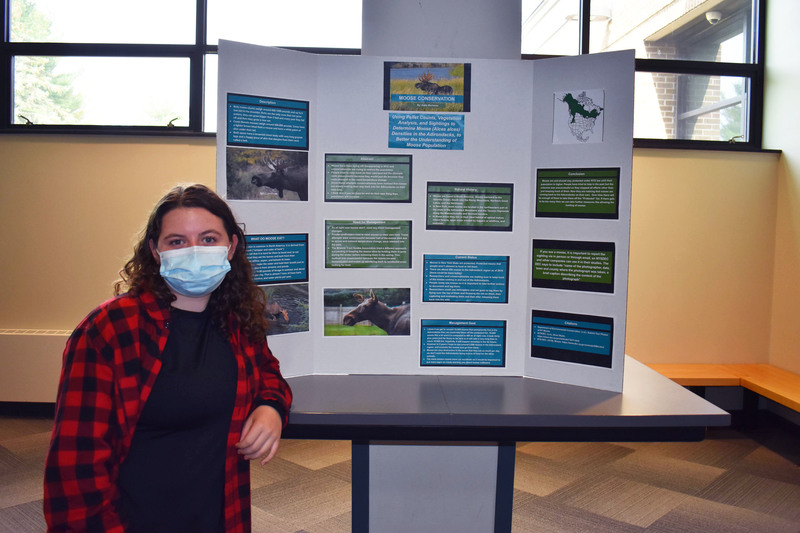 Conservation student Katie Marhaver poses next to her project