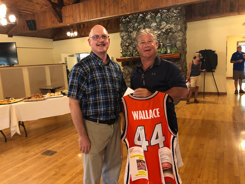 Gary Farquar from Gehring-Tricot Corp. poses with Mount Markham Board of Education member holding John Wallace jersey