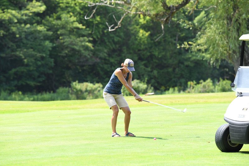 Golfer takes a swing