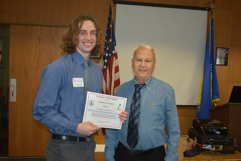 Student Nathan Draper poses with certificate and Legislator Peter Mano in Herkimer County legislative chambers