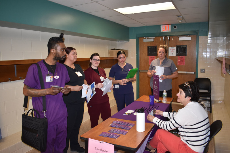 Five LPN students talking to an Excelsior College representative