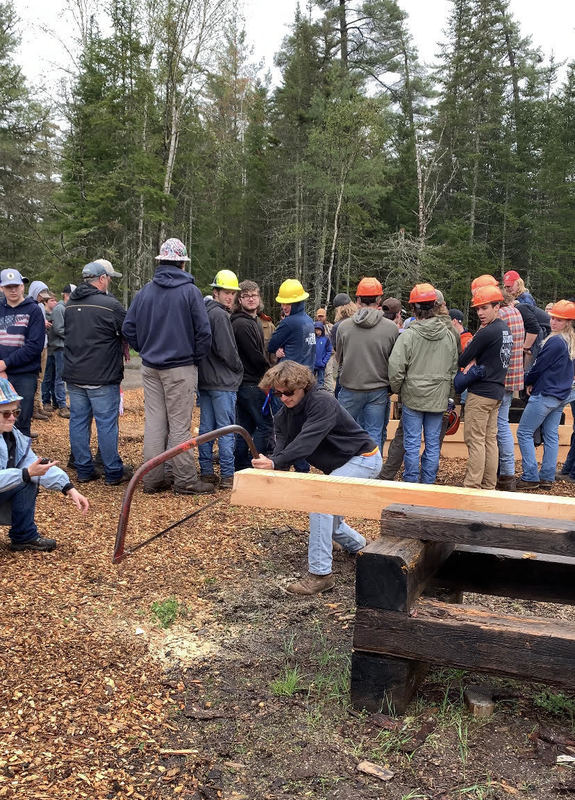 Conservation student doing a bow saw event