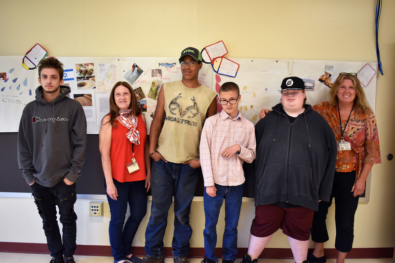 Career Awareness class students with their teacher and English teacher in front of their bucket list vision boards