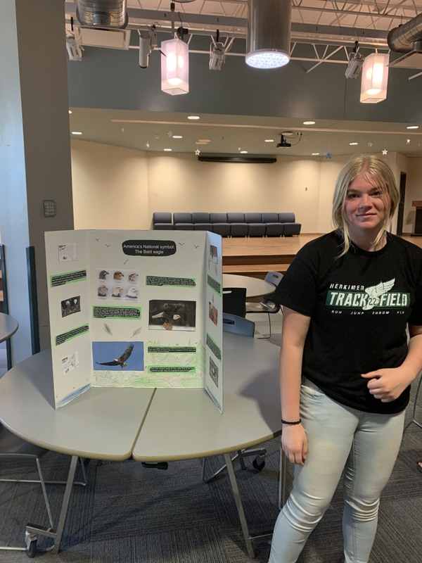 Conservation student standing by her animal conservation project