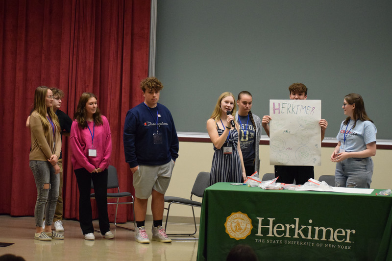 Herkimer Central School District students presenting on stage at the Youth Summit at Herkimer College