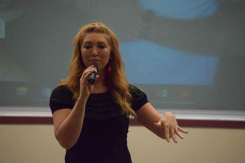 Singer and motivational speaker Jessie Funk singing on stage at Herkimer College during the Youth Summit