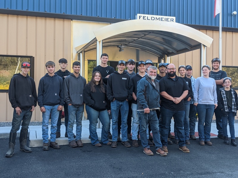 Herkimer BOCES Welding seniors pose outside Feldmeier facility with instructor and plant manager