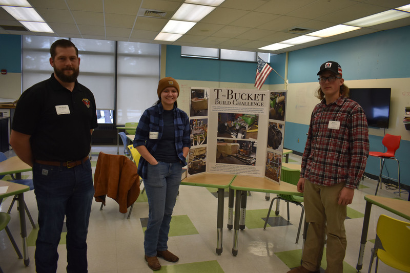 Herkimer BOCES Auto Tech exhibit with one teacher and two students