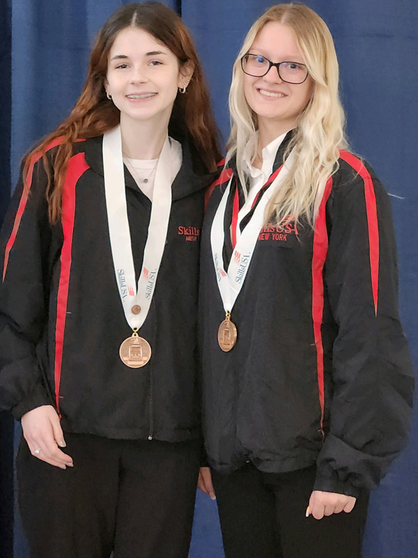 Two Cosmetology students pose with medals at SkillsUSA event