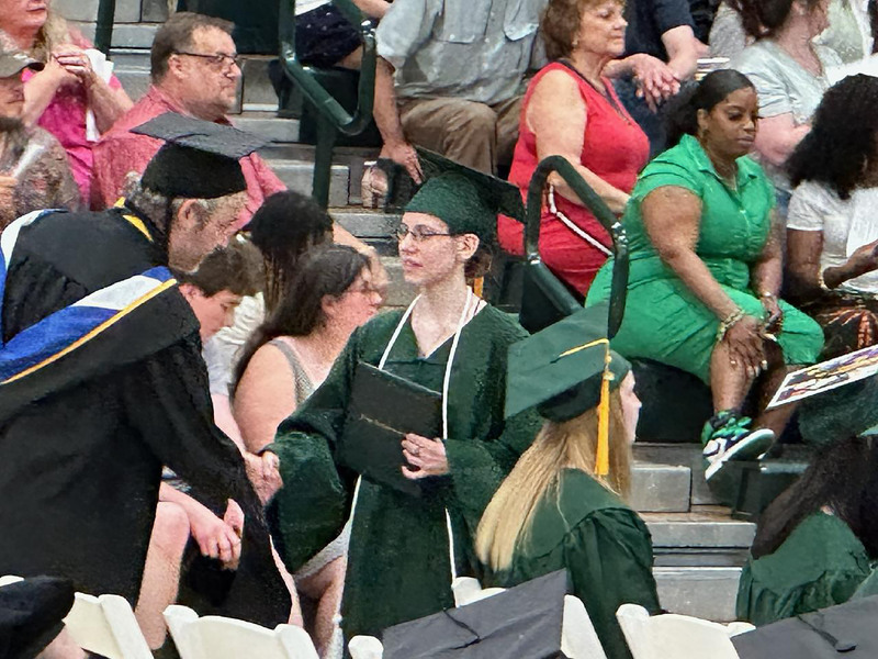Student shaking hands and receiving diploma