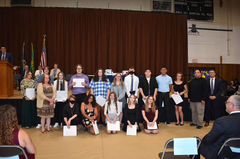 CTE completers pose in front of the stage at Herkimer College